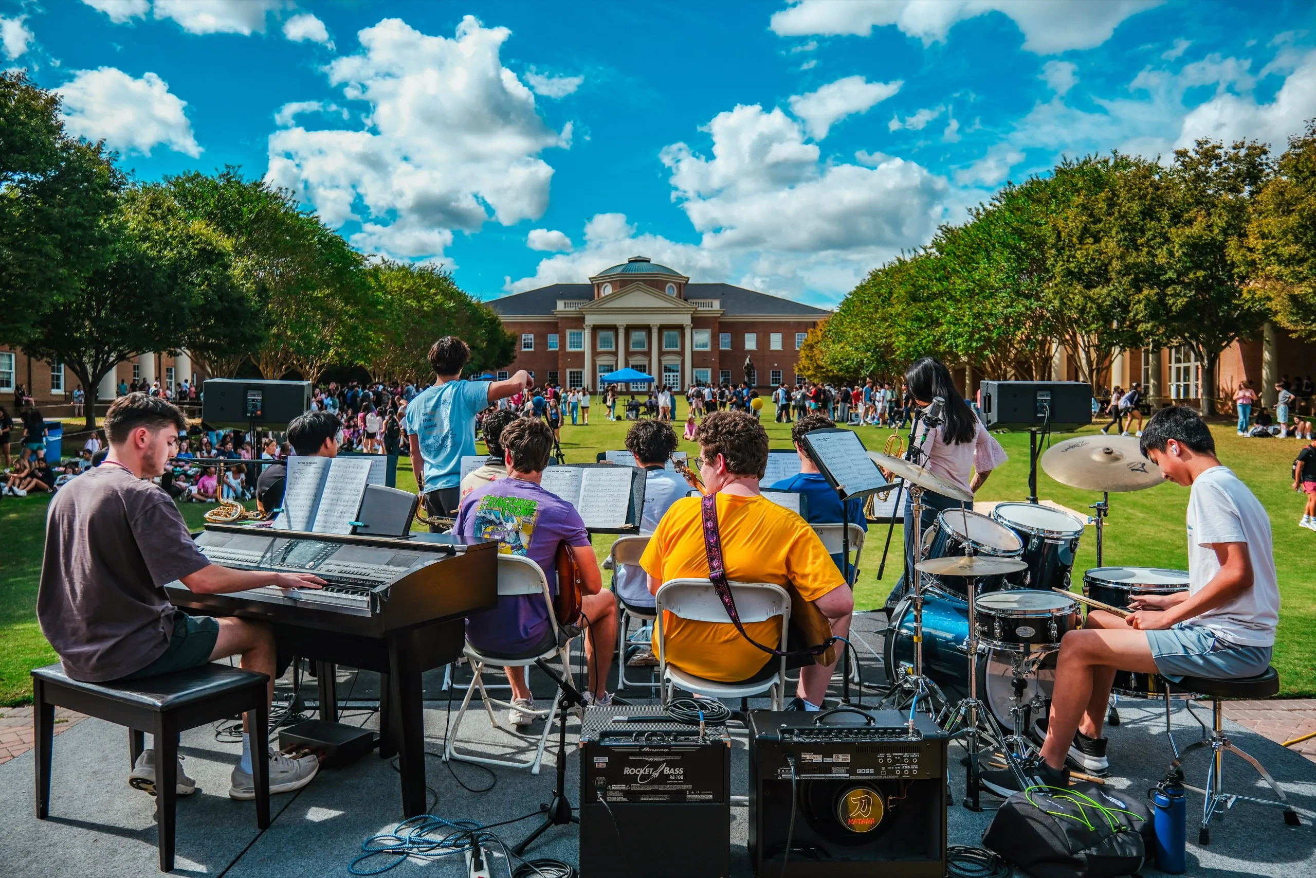 Students play in a band on the quad in front of the main building